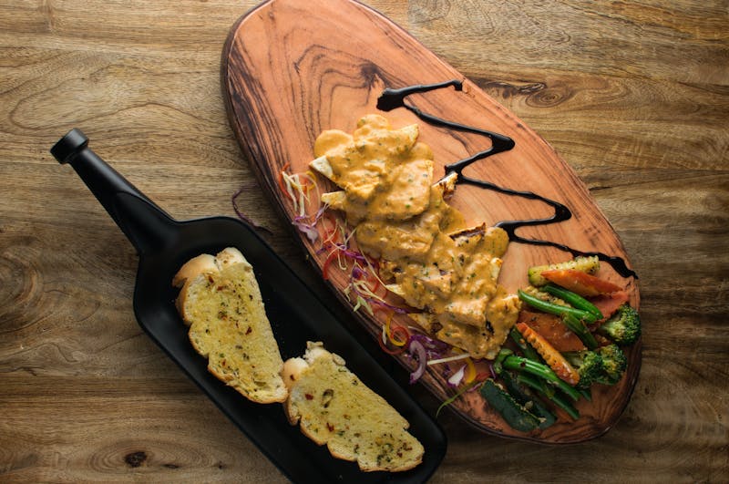 Reheated pizza slice in a cast iron pan staying crispy and delicious